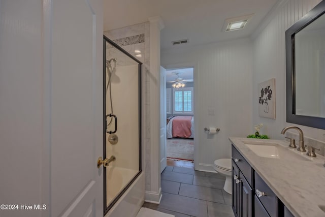 full bathroom with visible vents, toilet, combined bath / shower with glass door, vanity, and tile patterned floors