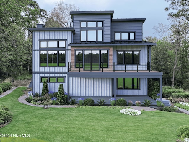 back of house featuring a lawn and a balcony