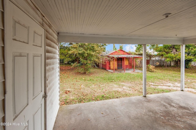 view of yard with a patio, fence, and an outdoor structure