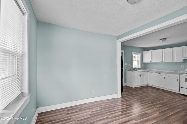 kitchen featuring white electric range oven, white cabinets, a textured ceiling, and dark hardwood / wood-style flooring