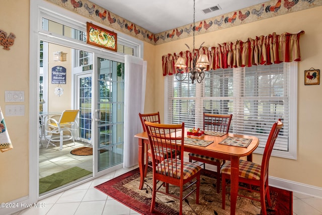 tiled dining space with an inviting chandelier and plenty of natural light