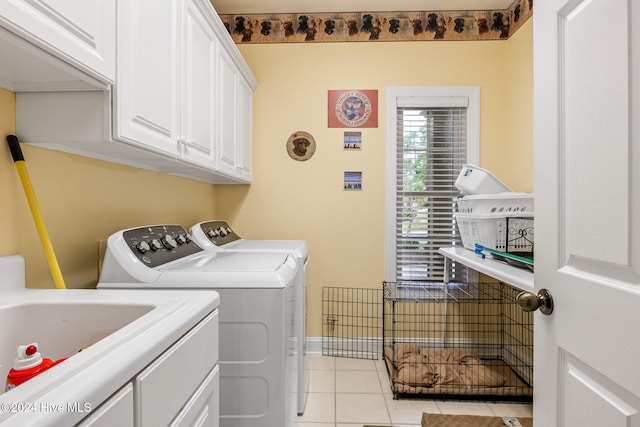 clothes washing area featuring cabinets, light tile patterned floors, and independent washer and dryer