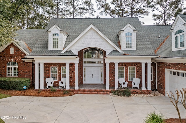 view of front of house featuring a garage and a porch