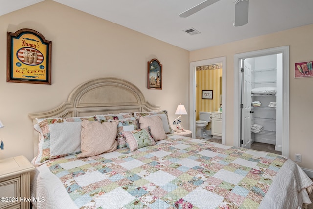 bedroom with lofted ceiling, a spacious closet, ceiling fan, and ensuite bathroom