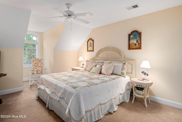 bedroom featuring light colored carpet, lofted ceiling, and ceiling fan