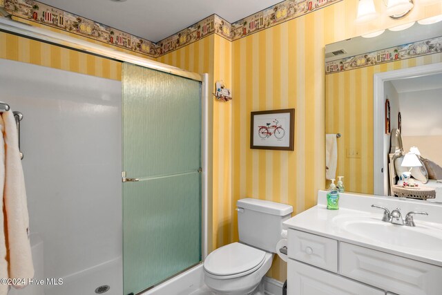 202 Jones Byrd Ct, Sunset Beach, NC 28468 - bathroom featuring a stall shower, wallpapered walls, vanity, and toilet