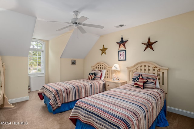 bedroom with vaulted ceiling, ceiling fan, and carpet floors