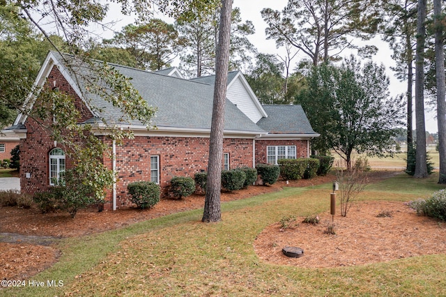 view of side of home featuring a lawn