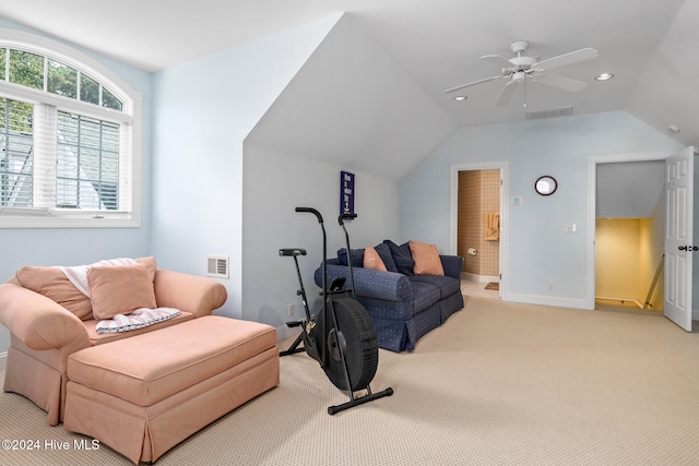 living area with lofted ceiling, light carpet, and ceiling fan