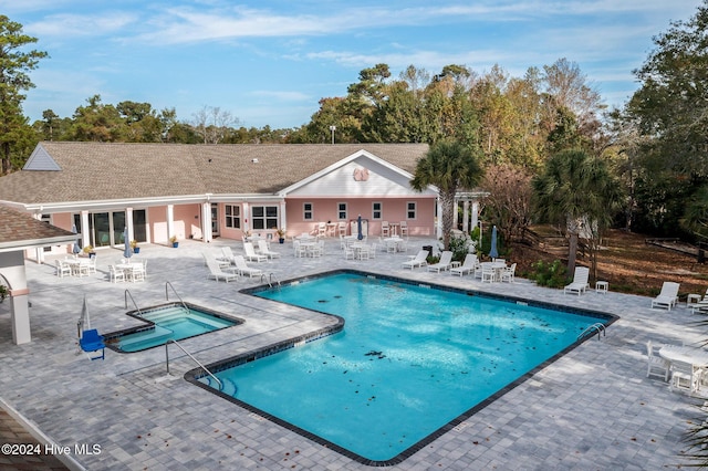 202 Jones Byrd Ct, Sunset Beach, NC 28468 - community pool with a community hot tub, a patio area, and view of wooded area