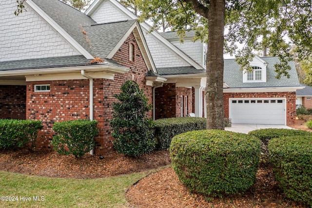 202 Jones Byrd Ct, Sunset Beach, NC 28468 - view of front facade with brick siding, roof with shingles, a garage, and concrete driveway