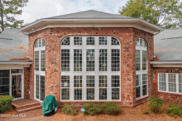 202 Jones Byrd Ct, Sunset Beach, NC 28468 - view of property exterior featuring brick siding and roof with shingles