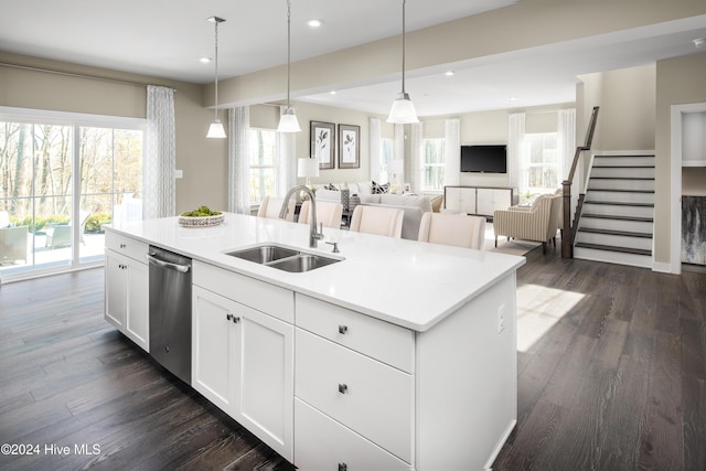 kitchen featuring a center island with sink, stainless steel dishwasher, plenty of natural light, and sink