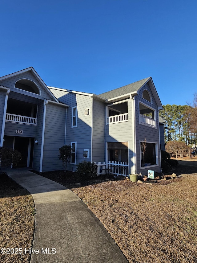 view of side of home featuring a balcony