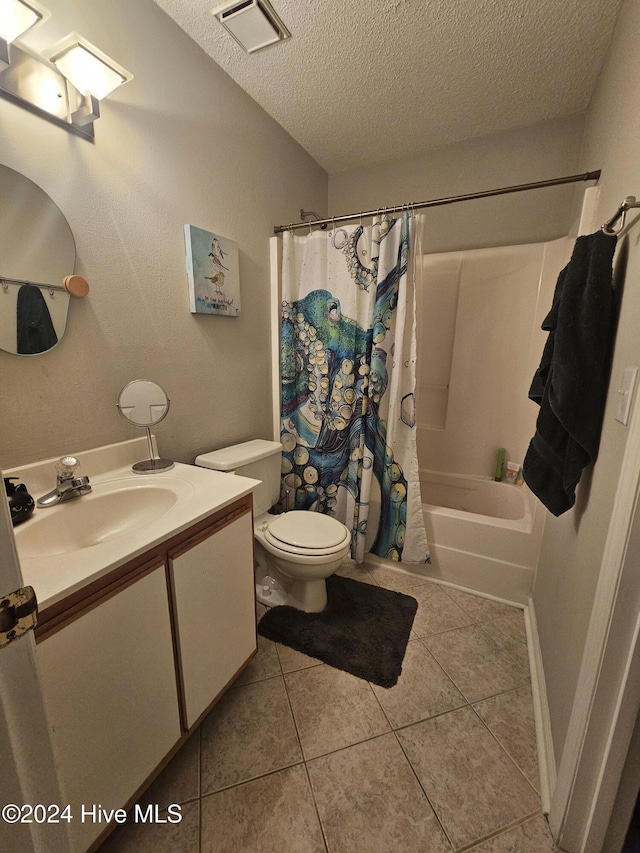 bathroom featuring a textured ceiling, toilet, vanity, visible vents, and tile patterned floors