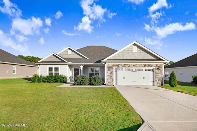 craftsman house with a front lawn and a garage