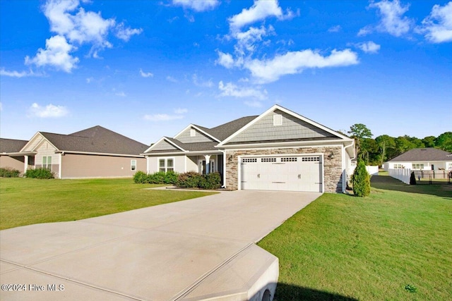 craftsman-style home featuring a front yard and a garage