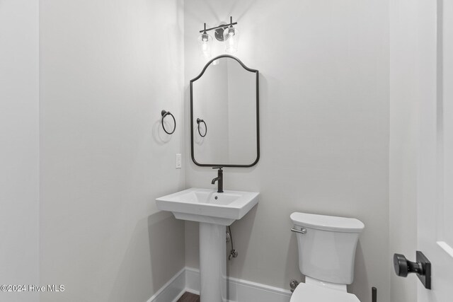 908 Second St S Unit 2, Carolina Beach, NC 28428 - bathroom with toilet and baseboards