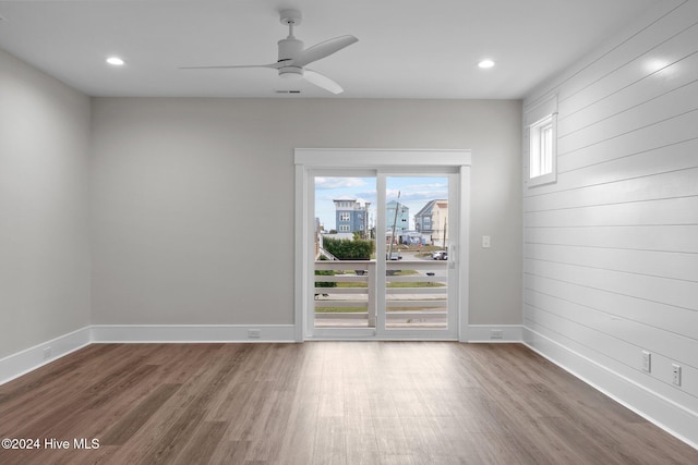 empty room featuring recessed lighting, ceiling fan, baseboards, and wood finished floors