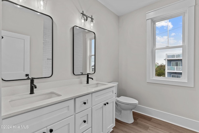 908 Second St S Unit 2, Carolina Beach, NC 28428 - full bathroom featuring baseboards, wood finished floors, toilet, and double vanity