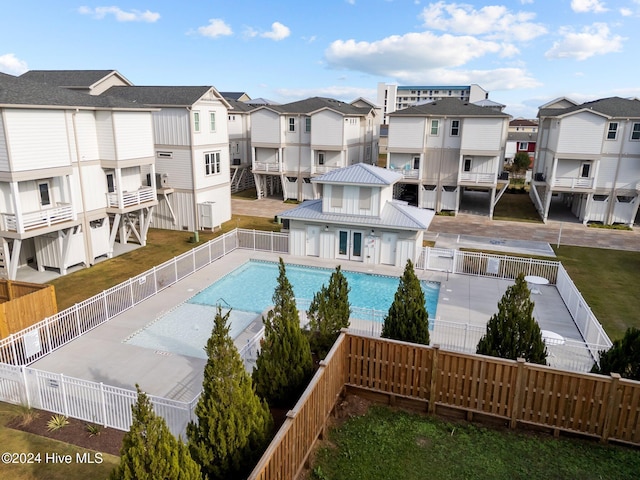 pool with a fenced backyard and a residential view