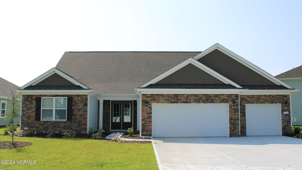 craftsman-style house with a garage and a front yard