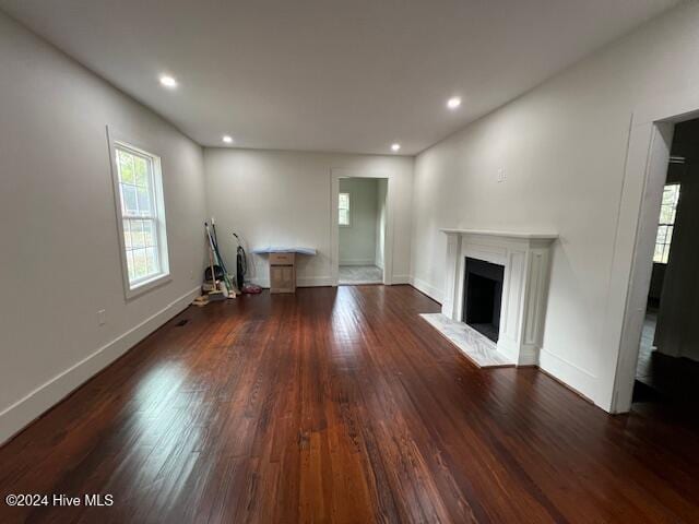 unfurnished living room featuring dark wood-type flooring