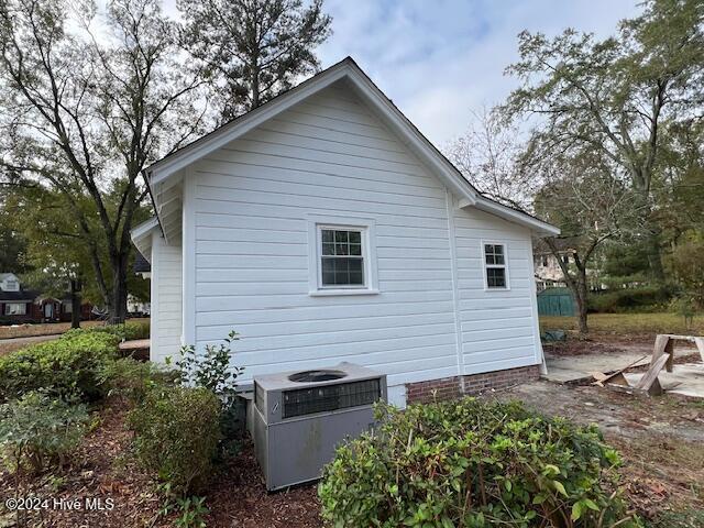 view of side of property with central air condition unit