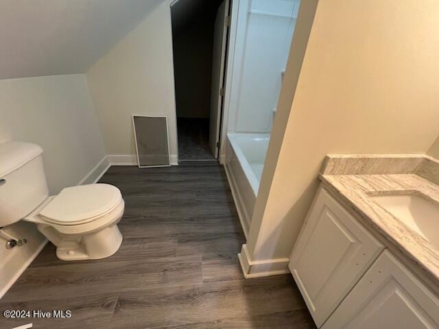 full bathroom featuring hardwood / wood-style floors, vanity, independent shower and bath, and toilet