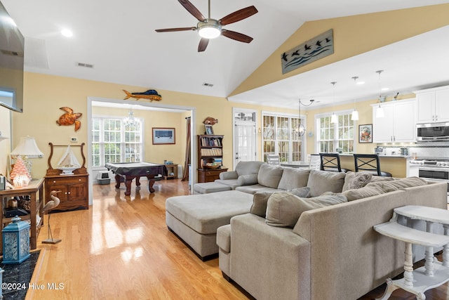 4151 Windham Ln, Southport, NC 28461 - living room featuring billiards table, light wood-style flooring, ceiling fan, a chandelier, and high vaulted ceiling