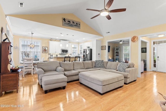 4151 Windham Ln, Southport, NC 28461 - living area featuring ceiling fan, light wood finished floors, a chandelier, and high vaulted ceiling