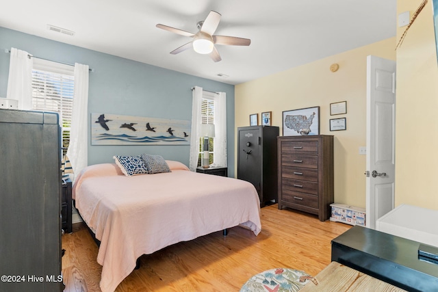 4151 Windham Ln, Southport, NC 28461 - bedroom with light wood-style floors and ceiling fan