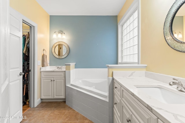 4151 Windham Ln, Southport, NC 28461 - bathroom with a spacious closet, tile patterned flooring, a bath, and two vanities