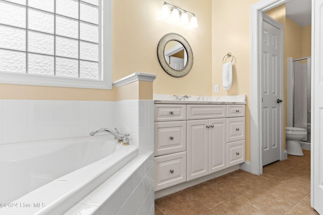 4151 Windham Ln, Southport, NC 28461 - bathroom featuring tile patterned floors, vanity, a garden tub, toilet, and an enclosed shower