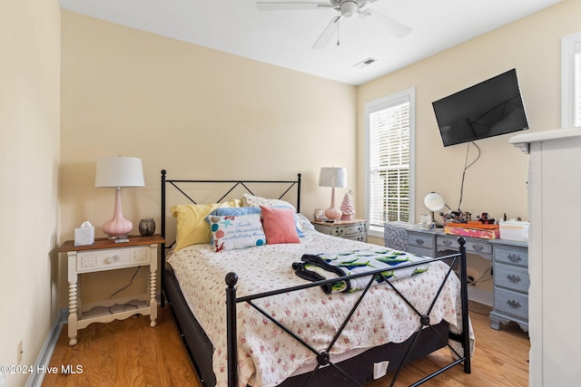 4151 Windham Ln, Southport, NC 28461 - bedroom with light wood finished floors, ceiling fan, and baseboards