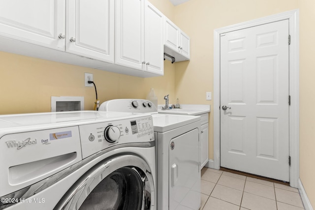 4151 Windham Ln, Southport, NC 28461 - washroom featuring washing machine and dryer, cabinet space, light tile patterned floors, and baseboards