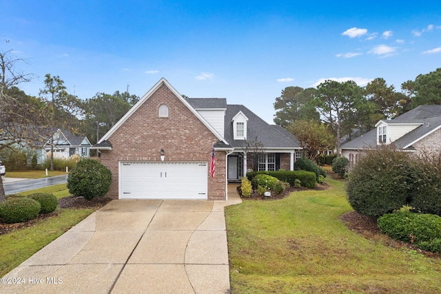 4151 Windham Ln, Southport, NC 28461 - view of front of house featuring brick siding, concrete driveway, a front yard, and roof with shingles