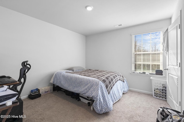 bedroom featuring multiple windows and light carpet