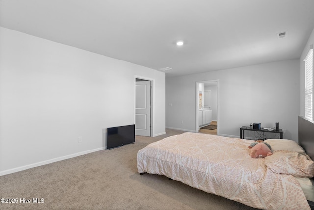 carpeted bedroom with ensuite bath