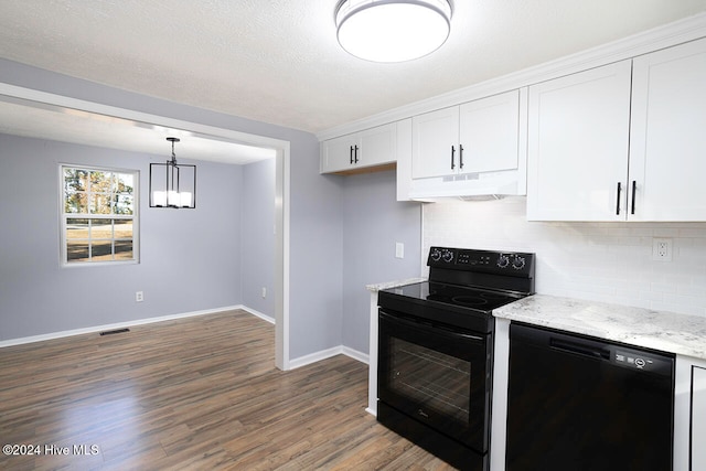 kitchen featuring white cabinetry, black appliances, light stone countertops, dark hardwood / wood-style floors, and hanging light fixtures