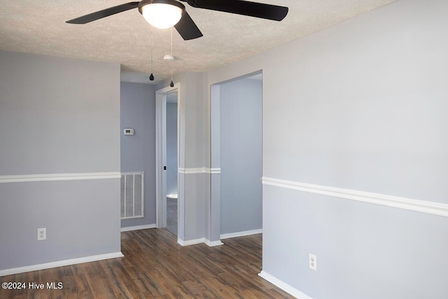 spare room featuring ceiling fan, a textured ceiling, and dark hardwood / wood-style flooring