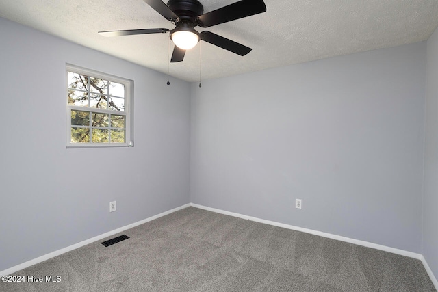 empty room with carpet floors, a textured ceiling, and ceiling fan