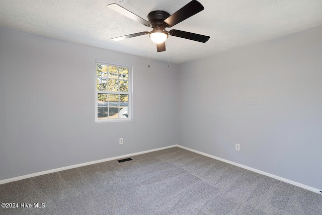 spare room with carpet flooring, a textured ceiling, and ceiling fan