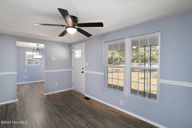 spare room featuring ceiling fan, a textured ceiling, and dark hardwood / wood-style flooring