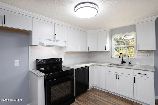 kitchen with black appliances, tasteful backsplash, white cabinetry, sink, and dark wood-type flooring