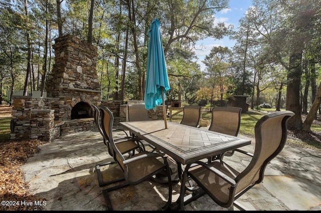 view of patio / terrace featuring an outdoor stone fireplace