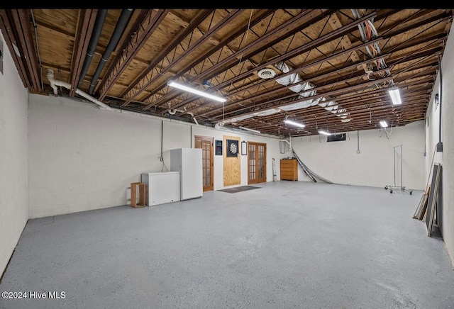 basement with white refrigerator and fridge