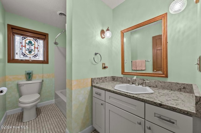 full bathroom featuring vanity, tile patterned floors, toilet, a textured ceiling, and tub / shower combination