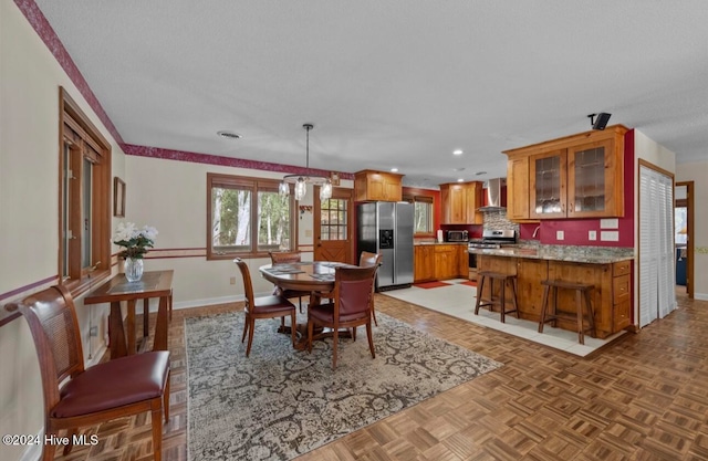 dining area with an inviting chandelier and light parquet floors