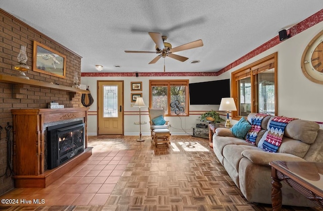 living room with a large fireplace, a healthy amount of sunlight, and a textured ceiling